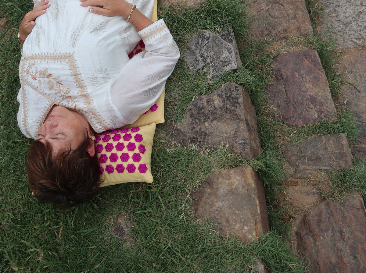 Sonja resting with her head on the LotuSun pillow, eyes closed, hands on her chest