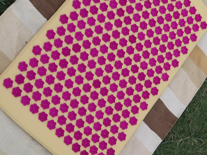 The LotuSun mat's magenta lotus-spike texture, in close-up and top-down
